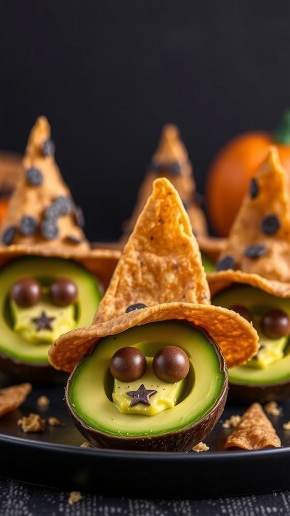 Cute avocado halves filled with dip and topped with tortilla chips as witch hats.